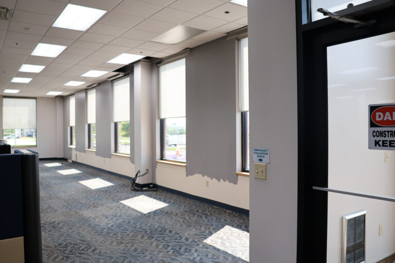 The existing interior of the office building before the false wall installation, and later expansion.