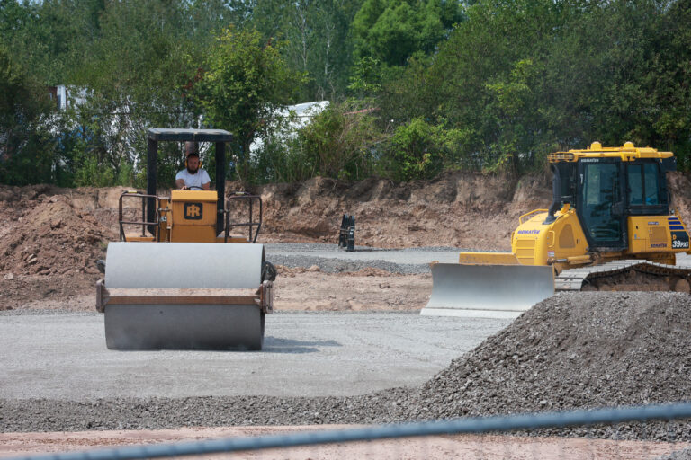 A road roller and bulldozer grade gravel for the Sealing Devices Lancaster campus expansion.