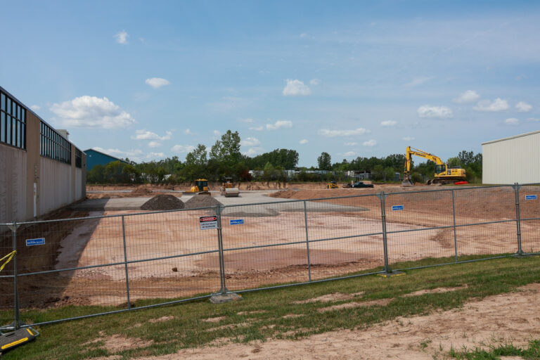 Excavators, rollers, and gravel piles at the Sealing Devices Lancaster campus expansion site.
